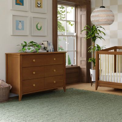 Mid-century modern, meet craftsman charm in the Babyletto Sprout 6-Drawer Double Dresser. Versatile in design and function, the Sprout 6-Drawer Dresser seamlessly moves from the nursery to a big kid room with the option to buy a removable changer top. Six spacious, smooth-glide drawers provide ample space for a growing babe’s wardrobe. Pair it with the Sprout 4-in-1 Convertible Crib for a classic mid-century modern nursery. babyletto Color: Chestnut babyletto Sprout 6 Drawer 19.75" W Double Dres Mid Century Modern Nursery, Big Kids Room, Stylish Nursery, Kids Dressers, Nursery Crib, Convertible Crib, Kid Room, Double Dresser, 6 Drawer Dresser