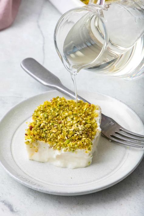 "Layali Lubnan," a Lebanese semolina pudding, is a deliciously creamy and fragrant dessert with a crunchy pistachio topping. | Lebanese Semolina Pudding | Layali Lubnan Recipe | How to Make Semolina Pudding | Semolina Pudding with Ashta and Pistachios | Lebanese Nights Dessert | Lebanese Deserts, Layali Lubnan Recipe, Ashta Recipe, Layali Lubnan, Semolina Recipes, Flavoured Cakes, Semolina Recipe, Lebanese Sweets, East Dessert