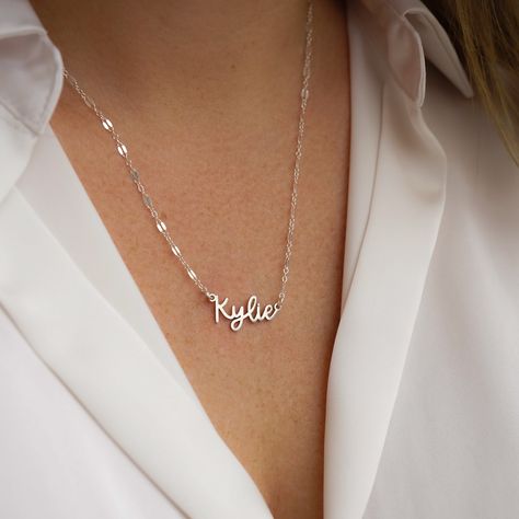 Escape to the Amalfi coast with our beautiful Amalfi Name Necklace! Its delicate design will turn heads and inspire confidence - making you feel like you can conquer anything! NECKLACE FEATURES Choice of 18k gold plating over sterling silver or Sterling Silver handcrafted custom name pendant (approx.* 1", up to 10 characters) Choice of Metal: Gold Fill or Sterling Silver Choice of Chain Style: Cable Chain or Upgraded Specialty Link Chain All necklace findings are gold filled/sterling silver. Eac Silver Name Chain, Silver Name Necklace, Name Pendant, The Amalfi Coast, Freshwater Pearls Earrings, Delicate Design, Chain Extenders, Yellow Gold Chain, Pretty Earrings