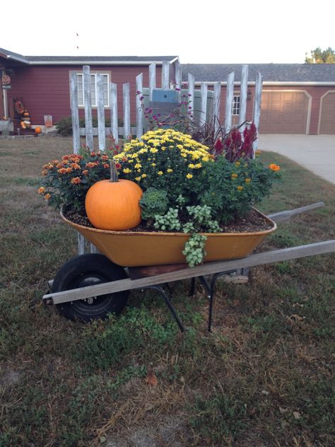 Fall in an old wheelbarrow Autumn Wheelbarrow, Wheel Barrow Fall Decor Outdoor, Fall Wheelbarrow Ideas, Wheel Barrow Fall Decor, Mexican Patio Hacienda Style, Wheelbarrow Planter, Wheelbarrow Garden, Fall Yard Decor, Classy Halloween Decor