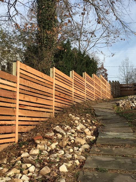 Hillside Fencing, Horizontal Fence On Sloped Yard, Low Fence Ideas, Hillside Fence, Horizontal Wood Fence On Slope, Cedar Fence Horizontal Modern, Ipe Fence Horizontal, Horizontal Wood Fence Retaining Wall, Horizontal Cedar Fence