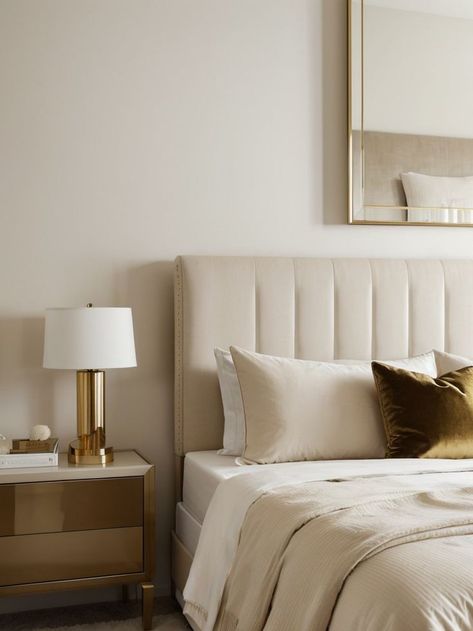 Create a serene and minimalist look by opting for a white bedroom with a beige accent wall. Add a touch of elegance with a velvet tufted headboard and complete the look with gold accents and soft neutral bedding. Accent Wall Beige, Beige Accent Wall, Beige Tufted Bed, Velvet Tufted Headboard, Beige Headboard, Grey Accent Wall, District 9, Neutral Bedding, Tufted Bed