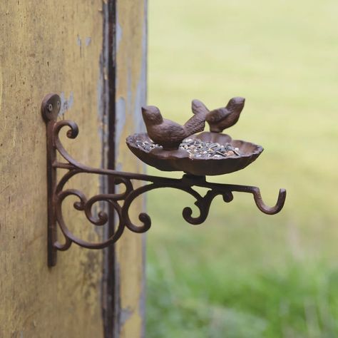 Hello friends! Our Wall Mounted Rotating Bird Feeder, features a cast iron ornate wall mounted hook topped with a 360 degree rotating bird feeder nest and two perched birds. This sweet bird feeder will add vintage charm to any cottage style home. Modern Bird Feeders, Bird Feeder Garden, Bird Feeder Station, Cottage Style Home, Modern Birds, Garden Art Crafts, Rustic Walls, Lantern Candle Holders, Bird Feeder