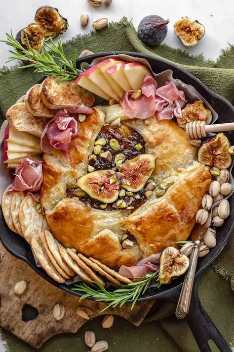 This baked brie with fig jam is an easy appetizer that's perfect for the holiday season or any gathering. Creamy brie cheese is covered with sweet fig jam and wrapped in a flaky puff pastry dough. Enjoy this delicious appetizer with fresh fruit, baguette slices, and prosciutto. Why You'll Love This Recipe While there are a lot to choose from, this is the baked brie recipe (also known as brie en croute) you need to try! Frequently baked with pecans and brown sugar, this is a nice chan… Baked Brie With Fig Jam, Brie With Fig Jam, Fig Appetizer, Creamy Brie, Baguette Slices, Fig Jam Recipe, Rough Puff Pastry, Pastry Appetizer, Plum Recipes