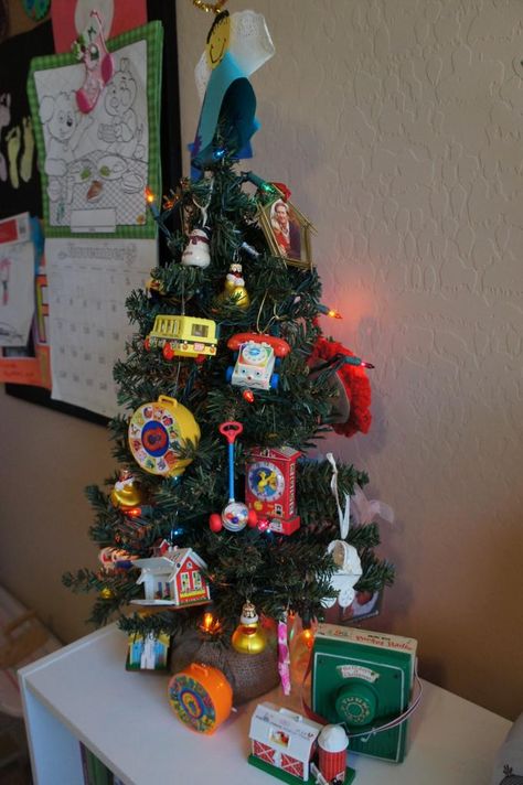 Fisher Price Ornament Tree. I have to do this next year! Vintage Fisher Price Toys, Hallmark Christmas Ornaments, Ornament Display, Christmas Tabletop, Ornament Tree, Fisher Price Toys, Christmas Swags, Holiday Christmas Tree, Halloween Trees