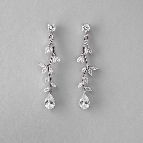 Create a stunning bridal look with our Long Vine CZ Wedding Earrings. These earrings are delicately crafted with a vine of marquise leaves featuring a single pear-cut CZ stone, that adds a touch of elegance to any wedding ensemble. They are about 2.5 inches long, rhodium or gold plated, made with AAA CZ stones, and lead, nickel, and cadmium free. Modern Wedding Earrings Bridal, Fall Wedding Earrings, Dangle Wedding Earrings, Silver Wedding Earrings, Icicle Earrings, Dangly Earrings Silver, Wedding Earrings Bride, Spring Ball, Vine Earrings