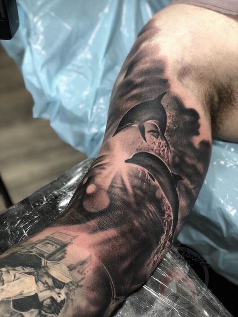 180 Creative Dolphin Tattoos Designs with Meanings (2022) - TattoosBoyGirl Hawaii Sleeve Tattoo, Ocean Background Tattoo, Dolphin Sleeve Tattoo, Dolphin Tattoo For Men, Sunset Sleeve Tattoo, Water Scene Tattoo, Dark Ocean Tattoo, Dolphin Tattoo Men, Ocean Tattoos Sleeve Underwater