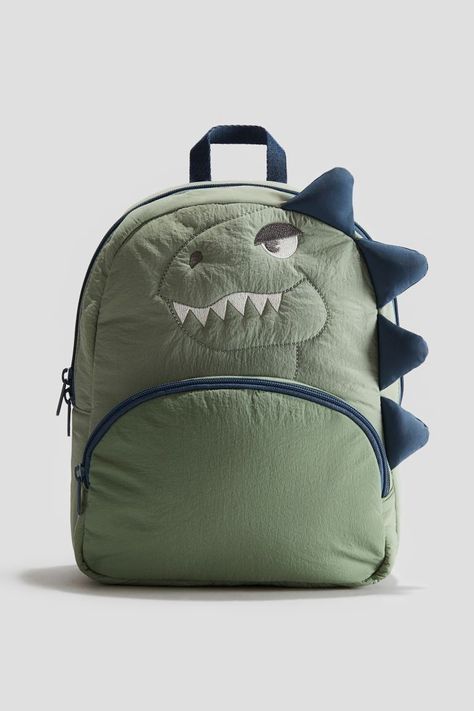 Appliquéd Backpack - Khaki green/dinosaur - Kids | H&M CA Witch Fancy Dress, Funky Sunglasses, School Uniform Kids, Beauty Gift Card, Green Dinosaur, Linen Storage, Baby Trend, Suit Shoes, Straw Bags