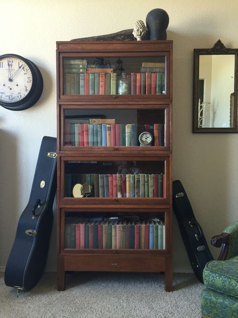 Lawyers bookcase full of vintage books in music room. Book Shelf Cabinet Design, Antique Book Shelf Ideas, Vintage Bookcase Aesthetic, Lawyer Bookcase, Lawyers Bookcase, Vintage Book Shelf, Bookshelf Vintage, Art Deco Bookcase, Bookcase Ideas