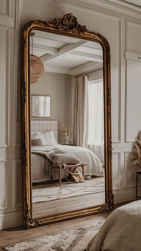 A large statement mirror adds light and space to a bedroom. Choose a round bohemian mirror, a tall vintage gold-framed mirror or a contemporary black-framed floor mirror to create a stunning focal point. Mirror In Master Room, Tall Mirror In Bedroom, Large Mirrors In Living Room, Floor Mirror In Bedroom, Vintage Floor Mirror, Gold Mirror Decor, Floor To Ceiling Mirror, Room With Mirror, Home Living Room Decor Ideas