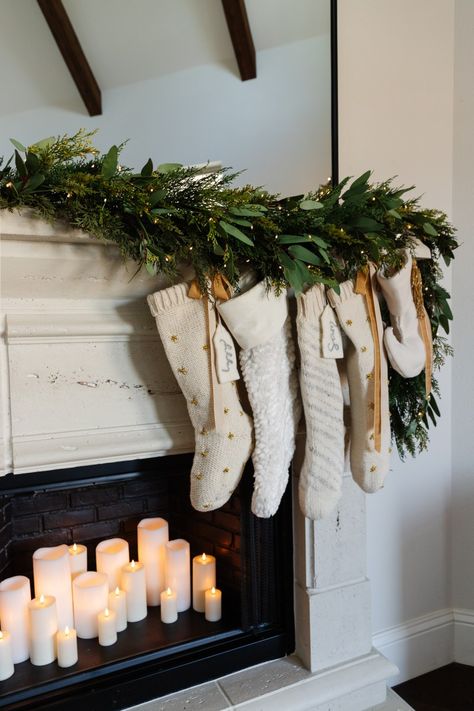 fireplace candles with asymmetrical Christmas garland and neutral stockings Charmed 1998, Slim Christmas Tree, Candles In Fireplace, Christmas Fireplace Decor, Christmas Mantel, Christmas Mantle, Christmas Fireplace, Ikea Pax, Christmas Mantels