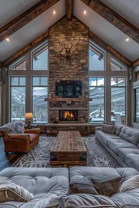 This living room captures the essence of a mountain lodge, featuring wooden beams and a stone fireplace. Fur rugs and antler decor add layers of warmth and rustic elegance. Embrace these rustic living room ideas for a home that's as inviting as a mountain retreat. Explore similar styles like ski chalet chic, alpine luxury, and rustic contemporary for your living space. Discover the full series of 16 mountain lodge inspired living rooms. Ski House Decor Interiors Rustic, Modern Ski House Living Room, Alpine Lodge Interior, Ski House Living Room Decor, Ski Living Room, Mountain House Interior Living Room, Chalet Home Decor, Mountain Style Living Room, Colorado Lodge Interior