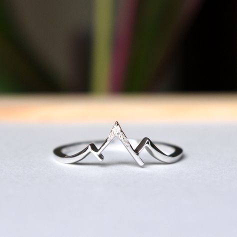 "3 mountain peak ring, crafted in solid 14k or 18k gold, this is a thoughtful promise ring for the two of you who met and fell in love in the mountains, for those who enjoy hikes together and want to spend lives together doing that!   Solid gold captures the warm glow of the sun shining on the snow-capped mountain peaks, illuminating the diamond studded ranges. It is the perfect ring for a winter or mountain proposal and wedding. A great gift for someone who loves trekking and camping and snow.  *  Gold: 14k / 18k Solid Gold  *  Gold Colour: Yellow / Rose / White  *  Gold Wt.: ~1.25 gm (14kt) *  Gemstone: Natural Genuine Diamond *  Diamond Wt.: ~0.02 Ct *  Color-Clarity: H-I, Vs-Si  * Authenticity Check: This ring will be marked for gold and will come with EGL (or equivalent) Certification Mountain Ring, Mountain Silhouette, Proposal Wedding, Sparkly Things, Wedding 2024, Gold Alloys, Wedding Jewellery, Custom Earrings, Cute Rings