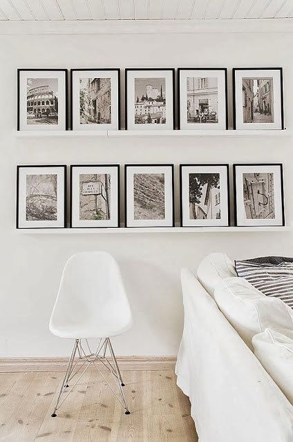 A touch of black in the form of framed black and white photos on the floating shelves adds just the right amount of contrast. Scandinavian Country Style, Travel Photos Display, Koti Diy, Diy Home Decor For Apartments, Creative Wall Decor, Photo Wall Gallery, White Living, White Living Room, Hang On