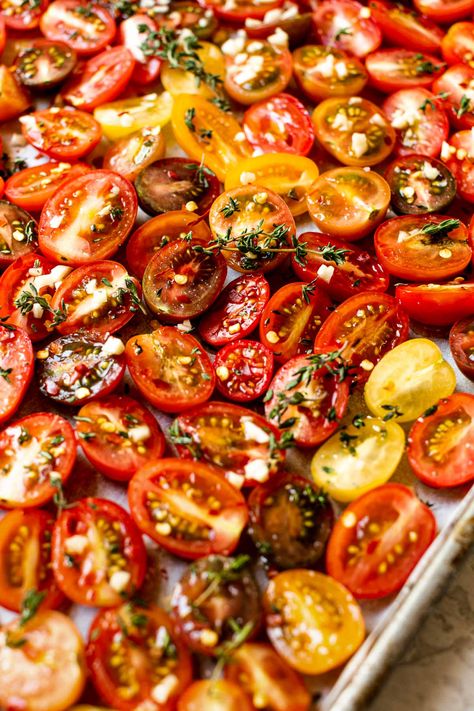 A Slow Roasted Cherry Tomatoes recipe, perfect for your summer garden harvest! Sweet & juicy cherry tomatoes slowly roast in the oven with olive oil, garlic, & fresh herbs, resulting in intensely sweet-tart tomatoes with the most wonderful hearty texture. Roasted tomatoes are perfect for tossing in pasta, salads, sandwiches, on pizzas, adding to a cheese board, or simply snacking by the handful – a summer staple! #roastedtomatoes #ovenroastedtomatoes #sundriedtomatorecipes #tomatorecipes Slow Roasted Cherry Tomatoes Oven, Sundried Cherry Tomato Recipes, Slow Roasted Vegetables, Sundried Cherry Tomatoes Oven, Slow Roasted Cherry Tomatoes, Slow Roasted Tomatoes Oven, Oven Dried Cherry Tomatoes, Roast Cherry Tomatoes In Oven, Sun Dried Cherry Tomatoes In Oven