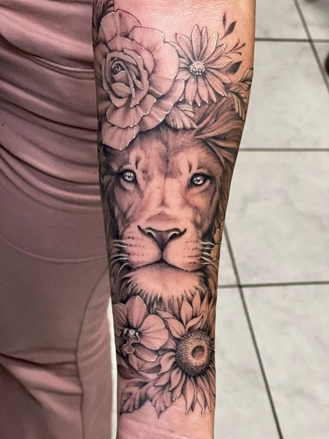 #lion #feminine #soft #floral #rose #orchid #daisy #sunflower #femaletattoo #forearm Sunflower And Lion Tattoo Sleeve, Lioness With Sunflower Tattoo, Lion And Daisy Tattoo, Lioness Tattoo For Women Thighs, Floral Lion Tattoo For Women, Sunflower Lion Tattoo, Lion And Sunflower Tattoo, Lion Floral Tattoo, Sunflower Sleeve Tattoos For Women