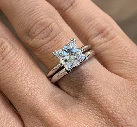 Celebrate your love and commitment with this exquisite Princess Cut Moissanite Wedding Ring Bridal Set. Expertly handcrafted, this set includes an engagement ring and a matching wedding band, designed to complement each other perfectly. The engagement ring features a mesmerizing princess cut Moissanite stone, known for its exceptional brilliance and fire. It is delicately set in a lustrous white gold band, accentuated by smaller, shimmering diamonds along the band. The matching wedding band is c Platinum Princess Cut Engagement Ring, Engagement Rings Plain Band, Princess Cut Engagement Ring With Band, Princess Cut Engagement Rings Gold, Solitaire Wedding Set, Set Wedding Rings, Solitaire Wedding Ring Set, Princess Cut Solitaire Ring, Engagement Ring Plain Band