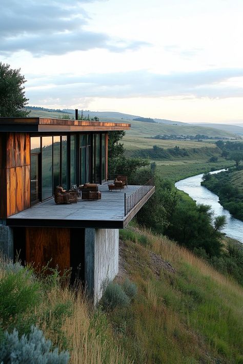 Earth sheltered modern house facade built into hillside with reclaimed wood and metal accents overlooking a river down the hill. Check out all of these stunning houses built into the hillside that look like they belong in a fairy tale. Hillside Building Architecture, Hillside Architecture Concept, House On Steep Hill, Small House Built Into Hillside, Downhill House Design, Hill Side House Design, House In Hillside, Hill Side House, Hill House Architecture