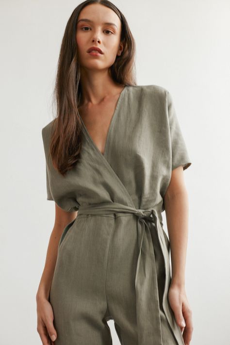 "AURORA is a short sleeve jumpsuit with belt. DETAILS - Wrap style top - Dolman sleeves - Self tie belt - Zip closure at the back - 100% lightweight European linen fabric - Cut and sewn to order just for you in our studio COLOR - Sage Green, you can also choose other colors above - Fabric samples are available here https://www.etsy.com/listing/586569696/linen-fabric-samples SIZING & FIT - Fits true to size - Model is 5'9.5\" / 177cm and wearing a size XS Tall CARE FOR LINEN - Machine wash up to 30ºC/86ºF gentle cycle - Lay flat to dry or tumble dry low - Warm iron if needed - Do not bleach SIZE GUIDE Size conversion guide Size XS (US 0-2, IT 36-38, UK 4-6, Japan 3-5, France 32-34) Size S (US 4-6, IT 40-42, UK 8-10, Japan 7-9, France 36-38) Size M (US 8-10, IT 44-46, UK 12-14, Japan 11-13, Overalls Linen, Jumpsuit With Belt, Linen Overalls, Short Sleeve Jumpsuit, Womens Jumpsuits, Wrap Jumpsuit, Studio Color, Linen Romper, Glad Rags