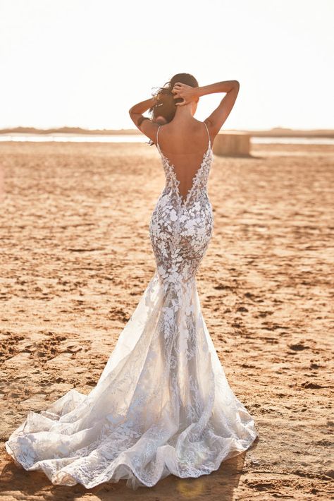 Feminine semi-transparent, lace-appliques wedding dress in white. Features a plunging V-neck, open back, long sheer tulle train and a beige lining. Milla Nova Wedding Dresses, Vestidos Boho, Bohemian Style Wedding Dresses, Milla Nova, Destination Wedding Dress, Fancy Wedding Dresses, Back Wedding Dress, Applique Wedding Dress, Dream Wedding Ideas Dresses