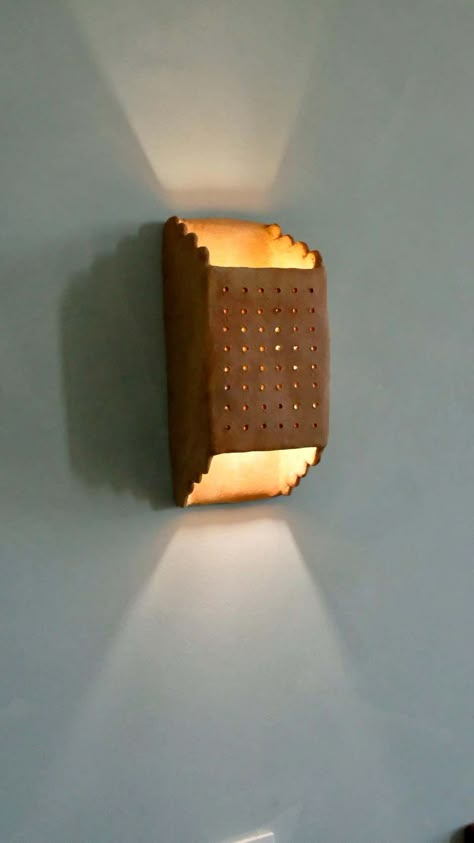 For Sale on 1stDibs - - Handbuilt terracotta ceramic wall light - made of clay collected from the potter's surroundings. - made in the Moroccan Rif mountains by the potter Houda. Wall Lamp Wood Design, Ceramic Wall Lights Sconces, Terracotta Wall Lights, Ceramic Illuminaries, Ceramic Wall Lamp, Clay Lighting, Ceramic Sconces, Terracotta Ceramics, Mediterranean Wall Sconces