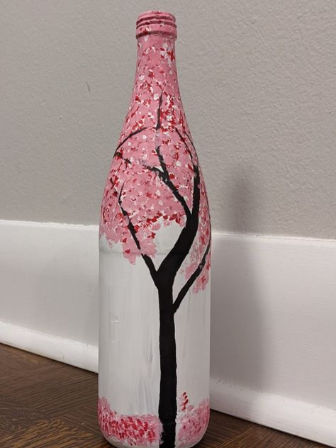 Painted this wine bottle with a cherry blossom scenery. Not my best piece, but not bad either for such a complex scenery. Used regular acrcylic paints Wine Bottle Painting Ideas Acrylic, Bottle Art Aesthetic Easy, Aesthetic Bottle Painting Easy, Plastic Bottle Painting, Easy Bottle Painting Ideas, Aesthetic Bottle Painting, Bottel Paintings Aesthetic, Painting On Glass Bottles Simple, Cherry Blossom Glass Painting