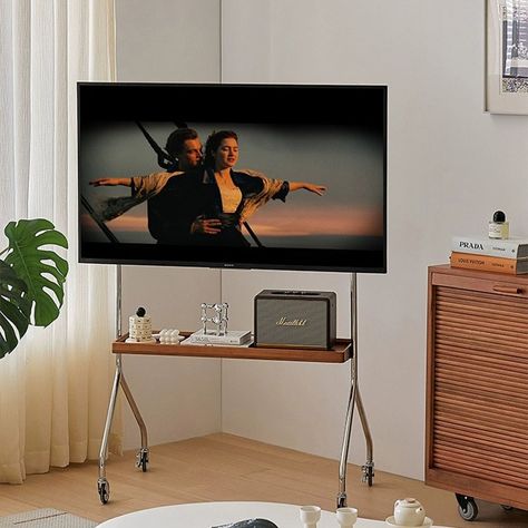 Open Concept Tv Placement, Weird Tv Placement, Samsung Frame Tv On Stand, Tv Stand Roll, Chrome Tv Stand, Small Space Tv Room Ideas, Tv Stand Mount, Tv Rolling Stand, Movable Tv Stand Ideas