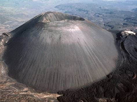 This is a cinder cone volcano.  Cinder cone volcanoes have a bowl shaped crater at the top of the volcano. The rock fragments are glassy and contain gas bubbles frozen into place . Cinder cones do not cause very destructive eruptions because the lava and debris that comes out dries very quickly.  Even though cinder cone volcanoes are not known for being destructive they can be very destructive sometimes. -- name? Cinder Cone Volcano, Volcano Types, Longest Word In English, Volcano Ash, Basic Geography, Lava Flow, Interesting Information, Data Collection, Science And Nature