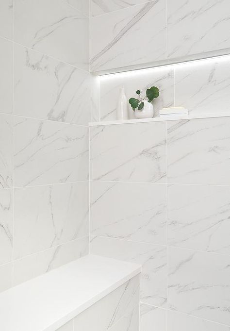 Shower features a marble niche with custom lighting over stacked marble shower wall tiles and a built in bench. Stacked Floor Tile, Marble Shower Niche, Marble Niche, Bathroom Ledge, Shower Wall Tiles, Prefab Walls, Modern White Farmhouse, White Marble Shower, Marble Shower Walls