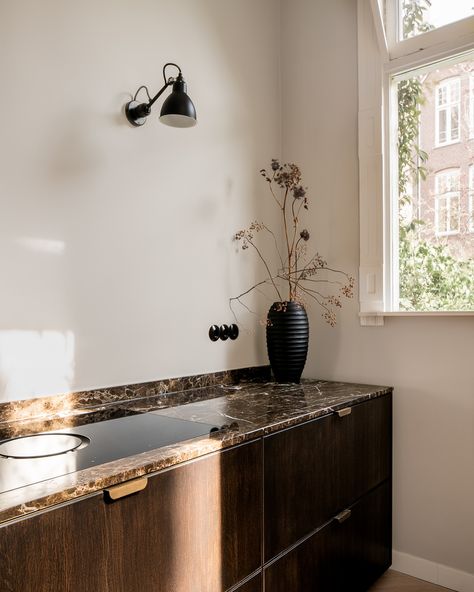 Step into this exquisite kitchen, where dark smoked wooden panels create a warm, inviting atmosphere. The natural stone worktop adds a touch of elegance, while the integrated cupboard with classic cannelures discreetly conceals an oven and offers ample storage space. Welcome to a space where craftsmanship meets timeless beauty. #handcrafted #kitchenelegance #urbankitchen #justusfelthuis #handmadewithlove #woodmeetsmarble Kitchen Stone, Urban Kitchen, Double Vanity, Timeless Beauty, Home Projects, Cupboard, Natural Stone, Entryway Tables, Storage Spaces