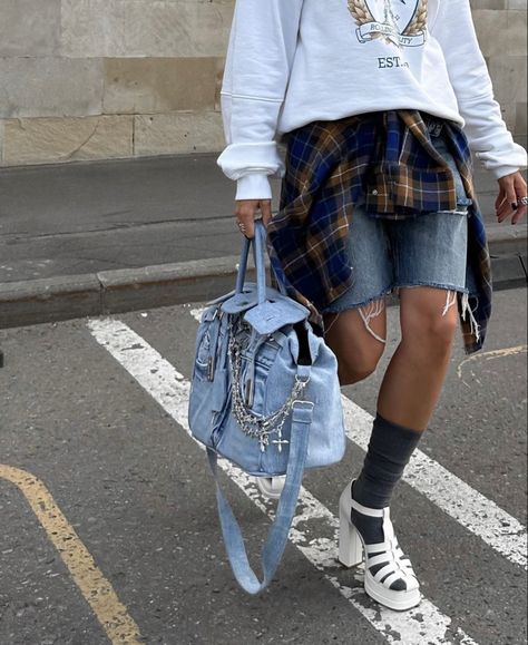 A girl wearing a jeans short, white sweatshirt, a orange and blue shirt, grey socks, white sandals and a jeans Birkin Hermès with jewels Chrome Hearts on it Birkin Outfit, Creative Bag, Gift Inspo, Sweatpants Shorts, Jeans Bag, Jelly Sandals, Street Style Outfit, Vintage Bags, Fashion Handbags