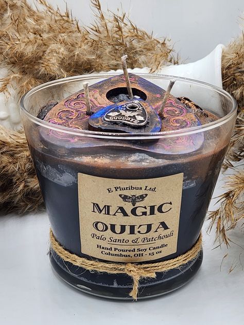 Thank you for  checking out my super spooky, but all in good fun emtertainment purposes only MAGIC OUIJA candle!   This quality candle is poured using quality, U.S. Soy Wax and Bees Wax using Clean, Chemical Free Scents and is inside a reusable little vase/urn. These make GREAT, show- stopping gifts for your friend or loved ones, especially those with ghost/ spooky/ spiritual Halloween decor. * *The design on the giant wax planchette will vary slightly from the shown example photos, as will the metal planchette charm. I get as close to my sample as possible each time.  **BURN time approx 100+ Hours Check out my other listings for a cool MAGIC TAROT marching candle! P.S. The best part is I include a unique collectible ouija planchette drink charm which is affixed by wax to the top of the ca Bee Wax Uses, Ouija Planchette, Pagan Decor, Witchy Gifts, Witch Candles, Spooky Candles, Food Candles, Halloween Time, Hand Poured Soy Candles