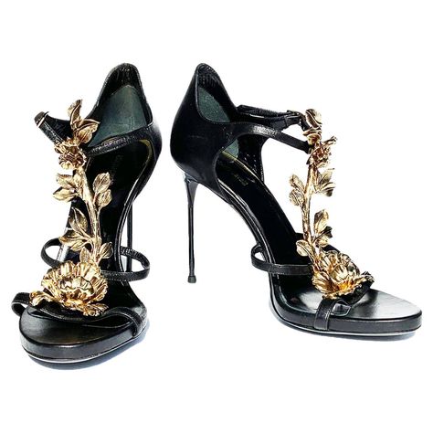 New Roberto Cavalli Metal Flowers Embellished T-Strap Sandals Italian size 38 ( US 8) Black Leather, Unique 3 D Gold - Tone Metal Embellishment, Adjustable Buckle, Stiletto Heel - 4 inches. Made in Italy. New without box. Velvet Thigh High Boots, Vintage Roberto Cavalli, Thigh High Heels, Leather High Heel Boots, Thigh High Boots Heels, Flower Shoes, Boot Jewelry, Unique Shoes, Gold Sandals