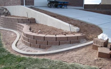 Curved Block Retaining Wall, Landscaping Slopes, Vinyl Fence Landscaping, Garden Wall Block, Office Decor Ideas For Work, Professional Office Decor, Small Retaining Wall, Landscaping Blocks, Backyard Retaining Walls