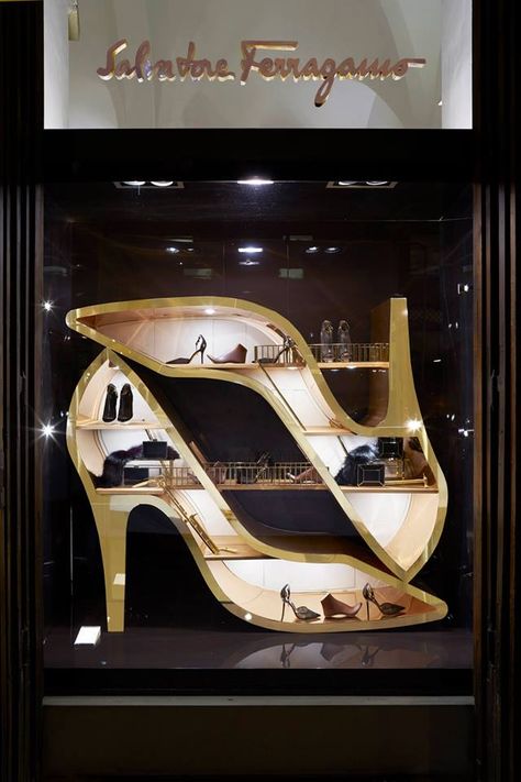 This display uses shadow boxing and large shoe cut-out props creating a proportioning effect that grabs attention. The shoes stand out against the light wood background, and the use of lighting. Shoe Store Display, Showcase Store, Dream Workshop, Shoe Store Design, Visual Merchandiser, Decoration Vitrine, Store Window Display, Visual Merchandising Displays, Store Window Displays