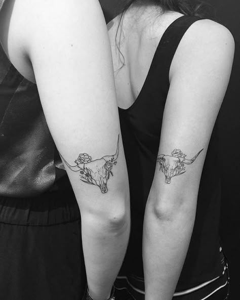 Matching sister tattoos of bull skulls by Jon Boy (left) and Evan Kim (right). Ox Tattoo, Cow Skull Tattoos, Tricep Tattoos, Bull Skull Tattoos, Cowgirl Tattoos, Tato Minimal, Cow Tattoo, Tattoo Placements, Horoscope Tattoos