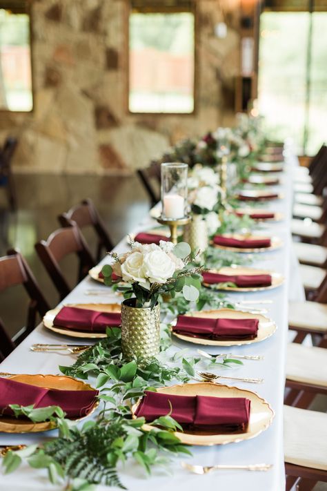 | maroon + gold wedding table decorations | elegant maroon wedding reception decor | 2018 maroon wedding ideas | elegant wedding color ideas | wedding centerpiece ideas for long tables | greenery wedding decor | wedding centerpiece with candles | photo taken at THE SPRINGS Event Venue. follow this pin to our website for more information, or to book your free tour! SPRINGS location:  The Lodge in Denton, TX photographer:  Kylie Crump Photography #weddingdecor #weddingdecorations #weddingcolors Maroon Wedding Reception, Maroon Gold Wedding, Gold Wedding Table Decorations, Wedding Table Decorations Elegant, Narnia Party, Elegant Wedding Colors, Gold Reception, Long Table Wedding, Greenery Wedding Decor