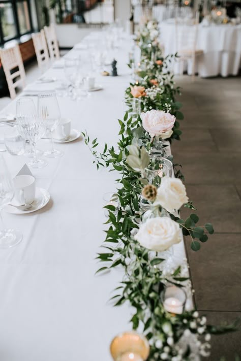 Flowers Laid On Table Wedding, Top Table Floral Display, Bridal Table Decorations Elegant, Wedding Registrar Table Flowers, Simple Top Table Decoration, Wedding Flower Centrepiece, April Wedding Centerpieces, June Wedding Flowers In Season, Top Table Flower Arrangements