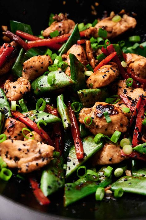 A close-up of a stir-fry dish featuring kung pao chicken - diced chicken, snap peas, and bell pepper strips, reminiscent of kung pao chicken, garnished with chopped green onions and black sesame seeds. Chicken Snap, Kung Pao Chicken Recipe Easy, Unique Chicken Recipes, Miso Chicken, Kung Pao Chicken Recipe, Chicken And Chips, Easy Chicken Recipe, Quick Stir Fry, Stir Fry Dishes