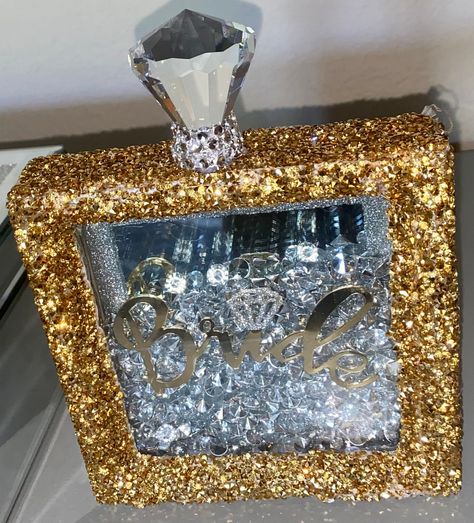 I hand made this shimmery bling shadow box with multiple detailed features including, a gold frame wrapped in sparkly gold rhinestones. Inside has a mirror backsplash for multipurpose use, crystal gems with a glittery diamond over any personalized word/name or phrase. To top of the look the box has an EXTRA large diamond crystal wrapped in clear rhinestones to mimic a perfume bottle top. Comes with or without fairy lights.  The perfect gift for a Bride or Bride to be. 💗Can be personalized  💗Fo Glass Mosaic Mirror, Mosaic Tile Mirror, Mirror Backsplash, Bling Crafts, Black Gold Ring, Jewelry Wall, Diamond Bling, Silver Vase, Bottle Top