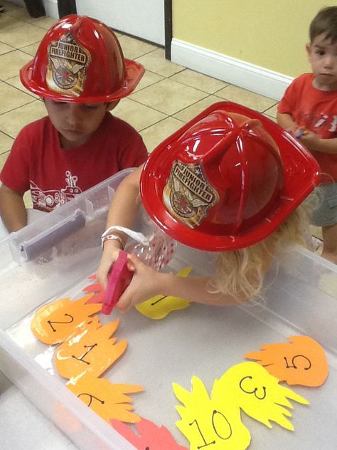 Great activity for a firefighter theme week at preschool. The kids loved spraying out the fire! Fire Prevention Science Experiments, Put Out The Flames Preschool, Firefighter Games Preschool, Community Helper Theme Preschool Activities, Career Preschool Activities, Fire Safety Games For Preschoolers, Fire Fighter Crafts Toddlers, Fire Fighter Activity For Toddlers, My Community Preschool Theme Activities