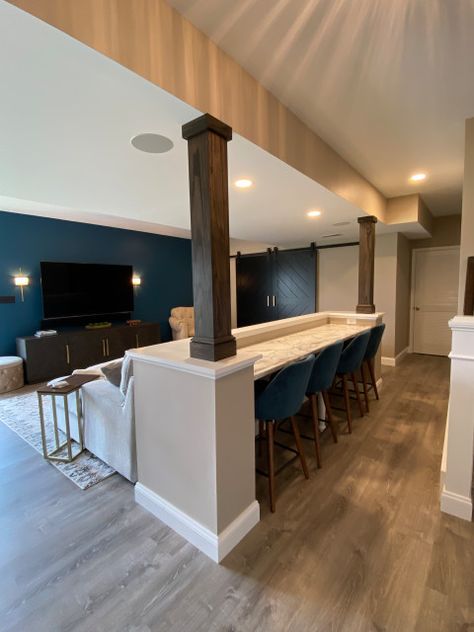 Basement With Support Poles, Finished Basement Remodel, Small Basement Bar With Seating, Basement Living Quarters, Downstairs Remodel Ideas, Basement Pull Out Couch, Fun Rooms To Have In Your House, Finished Basement Kitchen Ideas, Basement Media Room With Bar