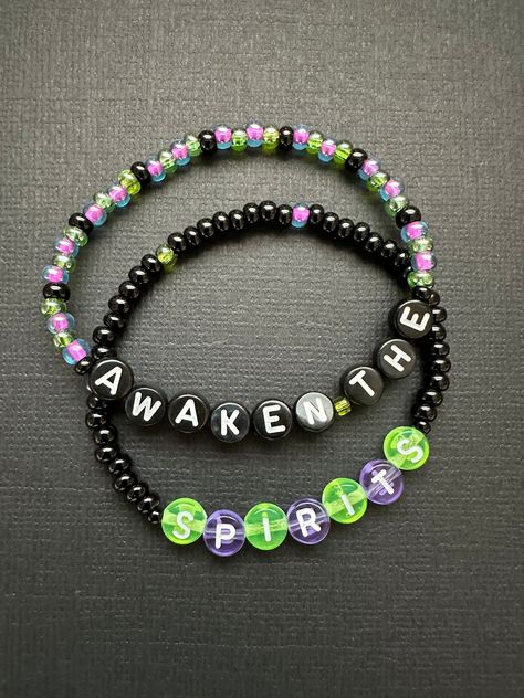 Awaken The Spirits with this set of two beaded stretchy bracelets. Spooky colors and translucent letter beads are the perfect fit for this haunted piece!  Bracelets are available in a variety of lengths.  Pick your custom length from the drop down menu below.  Please be aware that beading may slightly differ from what is pictured as to accommodate selected sizing.  All our bracelets are made with quality in mind.  With that being said, all bracelets should be treated with care while putting on, Beetlejuice Bracelet Ideas, Spooky Bracelet Ideas, Halloween Bracelet Ideas, Christmas Shoes Diy, Pony Bead Bracelets, Diy Kandi Bracelets, Halloween Bracelet, Letter Bracelet, Kandi Bracelets