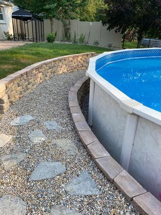 Building a Retaining Wall for an Above Ground Pool – Above Ground Pools Know it All Pool Edging Ideas Above Ground, Retaining Wall Ideas Hillside Pool, Above Ground Pool On A Slope, Rocks Around Above Ground Pool, Sunken Above Ground Pool Ideas, Above Ground Pool Retaining Wall, Retaining Wall Above Ground Pool, Pool Retaining Wall Ideas, Retaining Wall Around Pool