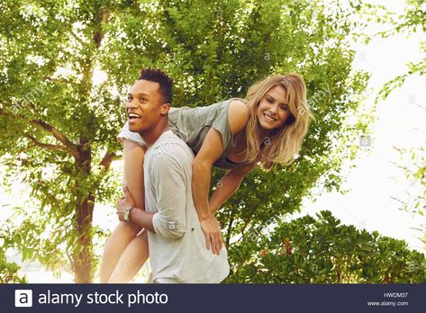 Download this stock image: Young man carrying female friend over his shoulder in park - HWDM37 from Alamy's library of millions of high resolution stock photos, illustrations and vectors. Carrying Someone Over Shoulder Pose Reference, Carrying Over Shoulder Pose Reference, Carry Over Shoulder Couple, Carrying On Shoulders Pose, Over The Shoulder Carry Pose, Carrying Person Reference, Man Carrying Woman Over Shoulder, Carrying Over Shoulder Pose, Person Carrying Person Drawing