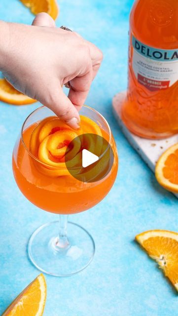 Delola on Instagram: "Make your Delola cocktails the star of the Friendsgiving table with these elegant orange rose ice cubes 🍊🍊🍊  Here’s how:  ✨Thinly cut six orange wheels, about ⅛ of an inch thick. Cut one wheel in half ✨Form five of the orange wheels into a rose shape in the ice mold ✨Roll the half wheel and place in center of rose formation in mold ✨Pour water ¾ of the way so that the orange slices are peeking out  ✨Freeze overnight  ✨Remove from freezer and add to glass  ✨Pour Delola L’Orange over ice rose" Orange Slice Ice Cube, Orange Ice Cubes, Rose Ice Cubes, Friendsgiving Table, Ice Rose, Cool Cocktails, Orange Wheels, One Wheel, Ice Molds