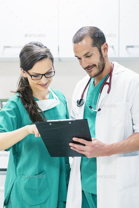 Doctor and nurse examining report of patient by nunezimage. Doctor and nurse examining report of patient. Medical Concept #AD #examining, #report, #Doctor, #nurse Health Photos, Doctor And Nurse, Medical Photos, Hospital Photos, Nurse Doctor, In Hospital, Clipboard, Fashion Website, Merchandise Design