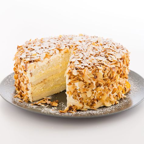 Layers of tender white cake are filled with creamy, almond-tinged custard and covered with fluffy amaretto buttercream and crunchy caramelized almonds. Toasted Almond Cake Recipe, Toasted Almond Cake, Burnt Almond Cake, Almond Cake Recipes, Burnt Almond Torte, Almond Cream Cake Recipe, Almond Cream Cake, Almond Torte, Cooked Frosting