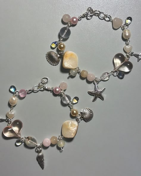 Matching beaded bracelets made with pearl and iridescent glass beads and a pastle color palette, resembling the sea/siren aesthetic.  Use promo code 2FOR25 when you buy both ! Inspo Beaded Bracelets, Mermaid Core Bracelet, European Beads Bracelet, Sea Themed Bracelet, Beaded Jewelry Aesthetic, Siren Jewelry, Vintage Heart Jewelry, Sea Bracelet, Siren Aesthetic