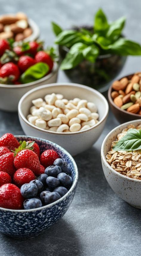 Fresh fruits, nuts, and grains arranged in bowls on a textured surface for a healthy meal prep stock photography Healthy Meal Photography, Meal Photography, Healthy Photography, Strawberry Almond, Healthy Nuts, Vegetarian Meal Prep, Strawberry Filling, Vector Christmas, Healthy Food Options